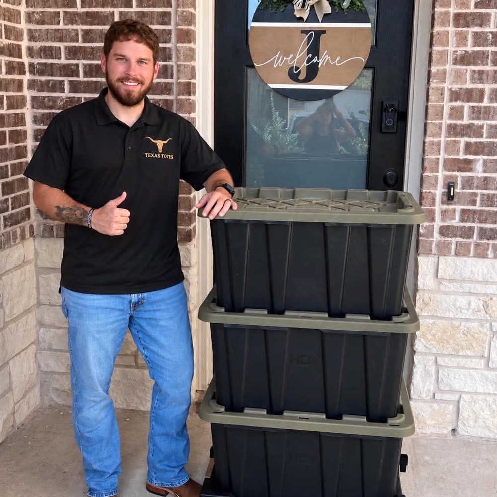 Brennon, owner of Texas Totes, with a stack of moving totes ready for delivery